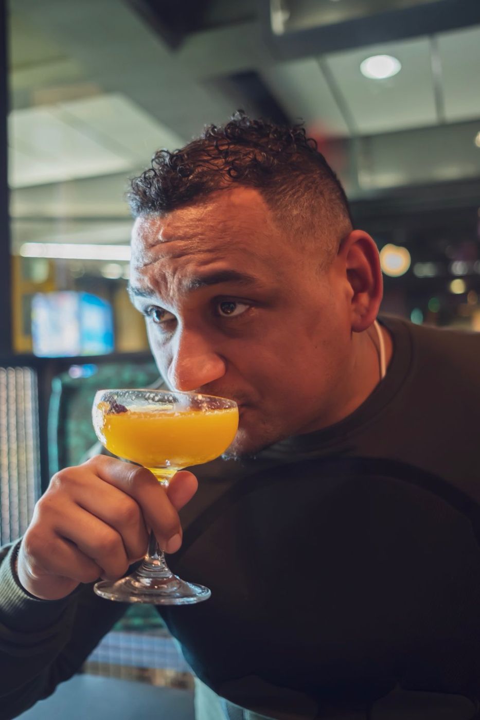 Shayne Williams tasting a cocktail